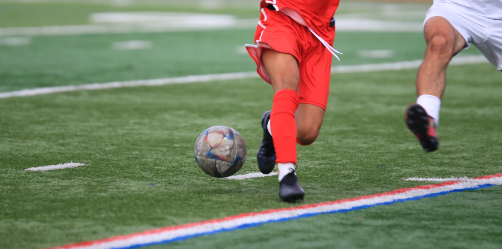 Soccer Players Compete for the Ball During an Intense Match on the Field